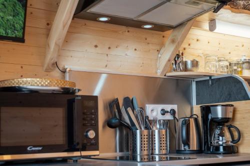 a kitchen with a counter top with a microwave at Gite L'insolite dans le Jura in Étival