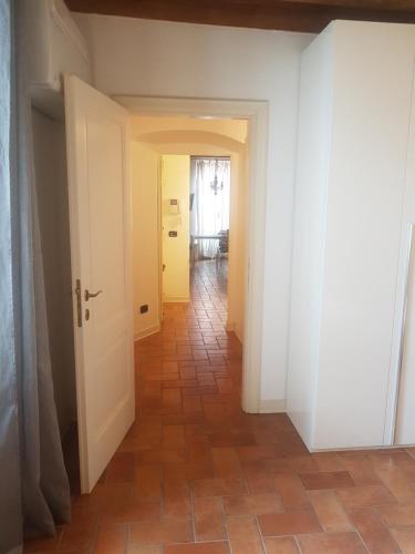 a hallway with white walls and a tile floor at L'Altana City House in Brescia