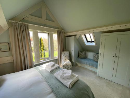 a bedroom with a large bed and a window at The Barn at Frog Pond Farm in Salisbury