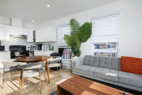 a living room with a couch and a table at Contemporary 2BR Retreat in MTL Village in Montréal