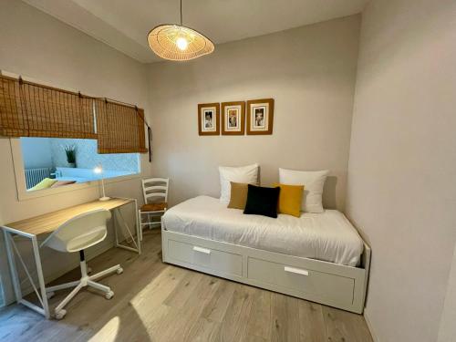 a bedroom with a bed and a desk and a desk at AppartCosy 21 Centre Historique T4 in Vitré