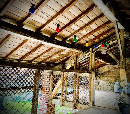 an old building with colorful lights hanging from the ceiling at La Main du Cœur Chambre d'hôtes de charme à la campagne in Loubens-Lauragais
