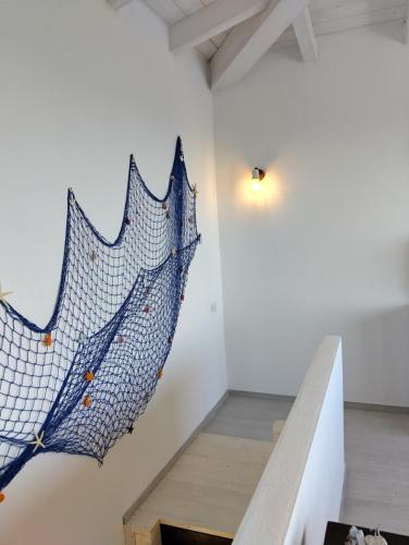 a painting of an umbrella on a wall in a room at La Medusa in La Ciaccia