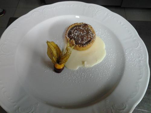 a white plate with a piece of dessert on it at Locanda del Boscogrande in Montegrosso dʼAsti