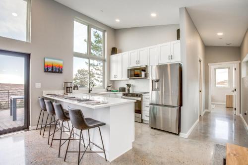 a kitchen with white cabinets and bar stools at Walk to Trail Lookout Landing Newly Built Home! in Golden