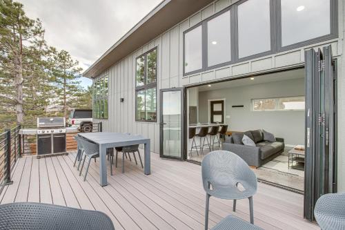 a house with a deck with a table and chairs at Walk to Trail Lookout Landing Newly Built Home! in Golden