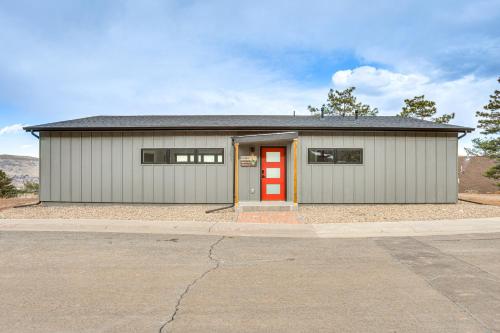 a large garage with a red door on a street at Walk to Trail Lookout Landing Newly Built Home! in Golden