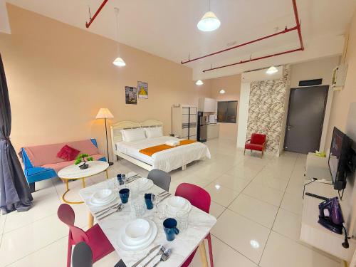 a large room with a bed and a table and chairs at 3 Towers Jalan Ampang By Serenity Vacation Homes in Kuala Lumpur