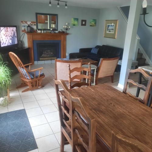 a living room with a table and chairs and a couch at Cottage by the beach in Wasaga Beach