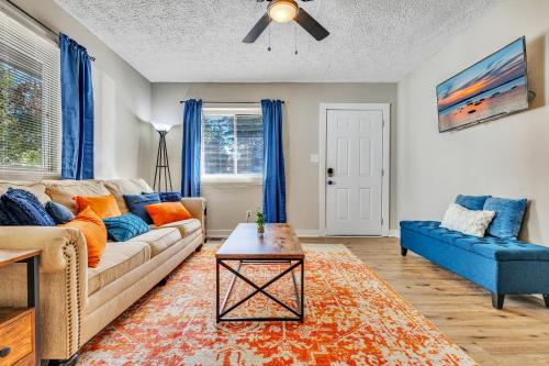 a living room with a couch and a table at Beautiful House Mins Away From the Airport in Atlanta