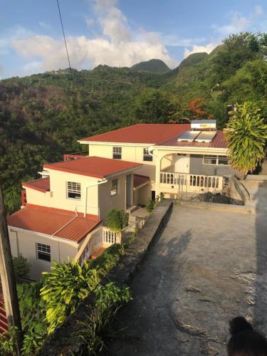 a house with a red roof on a mountain at Story Villa 2 Bedrooms with Mountain & Ocean View in Canaries