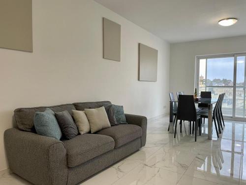 a living room with a couch and a table at Modern Cozy & Spacious Apartments in Malta - Perfect Stay Near Saint Julians in Is-Swieqi