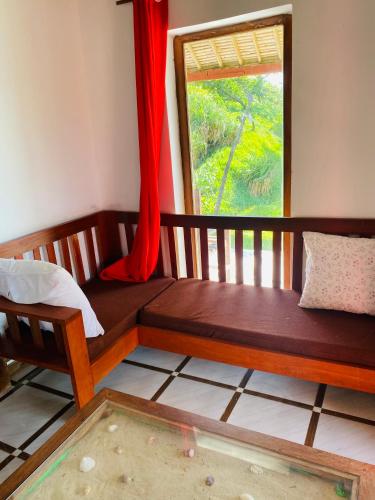 a room with a bed and a window at Nosy-Borah Holidays in Analabe