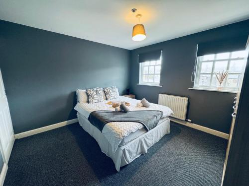 a bedroom with a bed with two teddy bears on it at Queens Townhouse - 4 Bedrooms - Sleeps 9 in Whitehaven