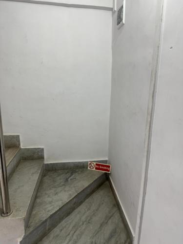 a sign in a corner of a room with stairs at Sadanand Home in Navi Mumbai
