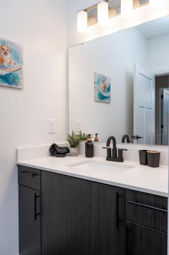 a bathroom with a sink and a mirror at Grandeur Unit Royal 103 in Whitestown