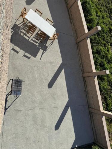 an overhead view of a table and chairs on a patio at casa habana in Carballino