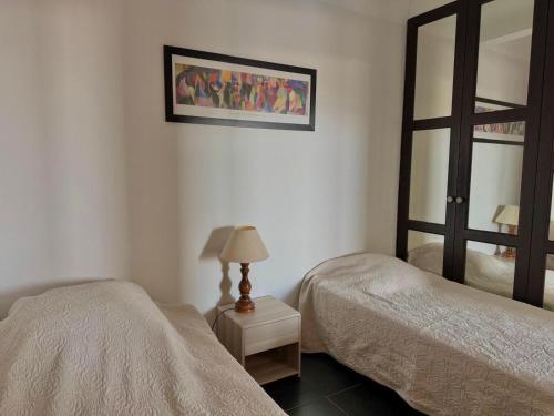 une chambre avec deux lits et un miroir dans l'établissement 1-bedroom beachfront apartment with sea view, à Cannes