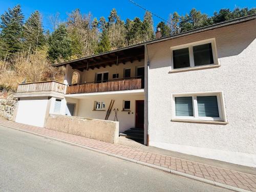 a building with a balcony on the side of a street at Haus Steiner #Mitten im Schwarzwald# in Lauterbach