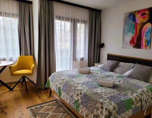 a bedroom with a bed and a table and a chair at Landhaus am Kurpark in Baden