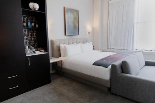 a hotel room with a bed and a couch at Stanton House El Paso in El Paso