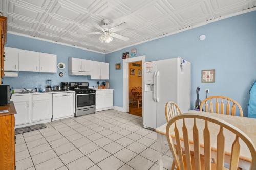 a kitchen with white appliances and a table and chairs at Southern Breezes Nor' Easter - close to the beach! in Cape Charles