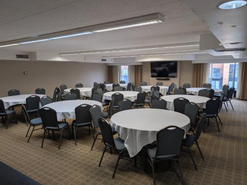 a room with rows of tables and chairs at Holiday Inn St. Paul Downtown by IHG in Saint Paul