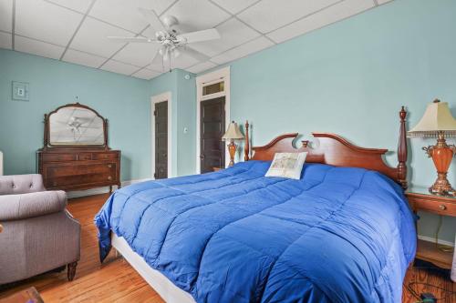 a blue bedroom with a bed and a ceiling fan at Southern Breezes Nor' Wester - close to beach! in Cape Charles