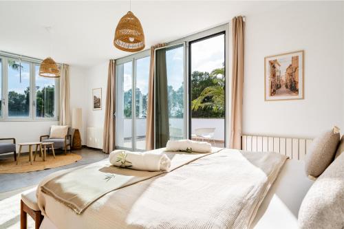 two beds in a room with windows at Can Toni in Sa Pobla