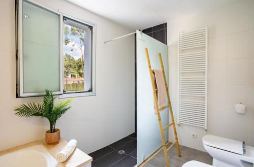 a bathroom with a toilet and a window at Can Toni in Sa Pobla