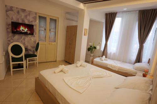 a hotel room with two beds and a fireplace at Golden Sleep Hostel in Shkodër
