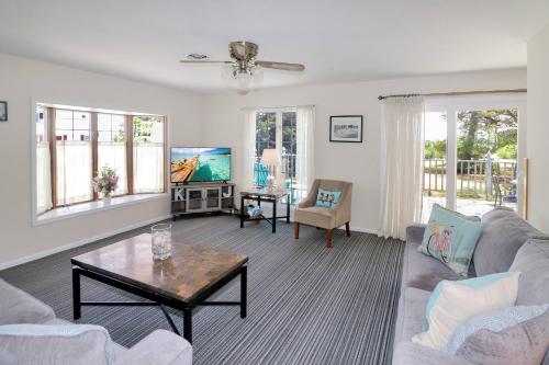 a living room with a couch and a table at Southern Dream - Water views & screened porch! in Deep Hole