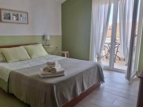 a bedroom with a bed with two towels on it at Apartment Patricia in Primošten