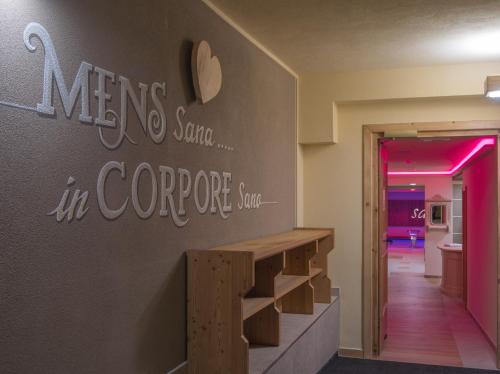 a room with a staircase with a sign on the wall at Hotel Amerikan in Livigno