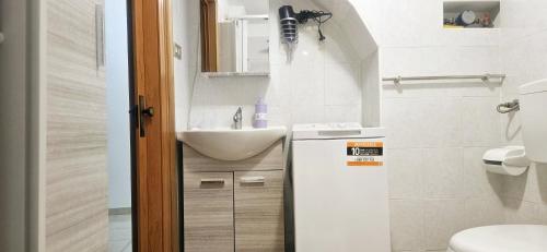 a small bathroom with a sink and a toilet at Nonna Rosa House - Cozy Apartment - Molfetta in Molfetta