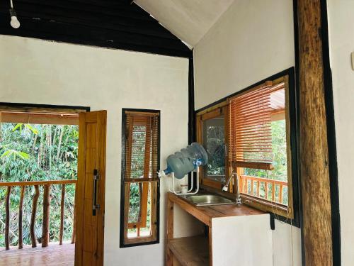 a kitchen with a sink and a window at are twin bungalows in Tetebatu