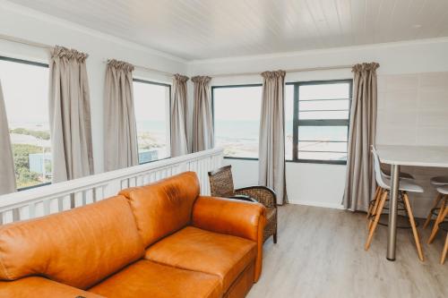 a living room with a couch and a table at Vooruitzicht in Gansbaai