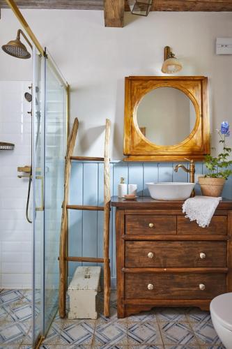 a bathroom with a sink and a mirror at Chatka na Roztoczu in Huta Lubycka