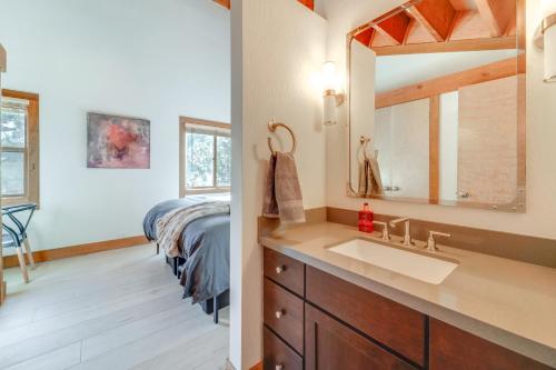 a bathroom with a sink and a bed at 8 Mi to Lake Tahoe Spacious Northstar Condo! in Truckee