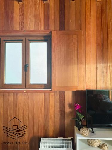 a room with wooden walls and two windows at Casa do Rio, Sever do Vouga in Paradela