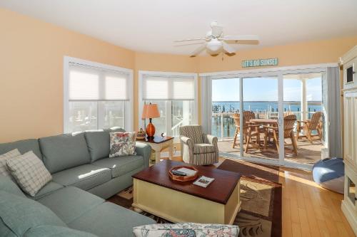 a living room with a couch and a table at Sunset Bay Villa 116 - Waterfront with shared pool! in Chincoteague