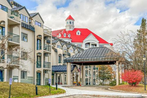 a building with a red roof with a clock tower at Autumn Colors Condo at Rivergreen in Lincoln