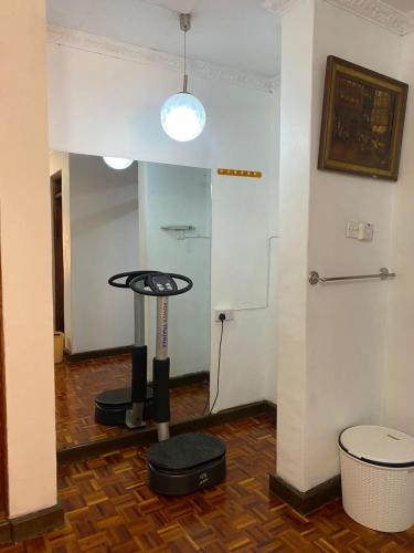 a room with a room with a table and a spotlight at Makazi Homes in Nakuru