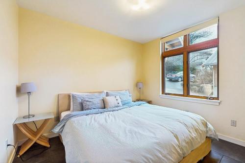 a bedroom with a bed and a window at No-Bank Waterfront Stunner – Driftwood Compound on Fidalgo Island in Anacortes