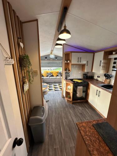 an open kitchen with a couch in the background at 8 berth Waterside Ingoldmells V8 Santanavan 3 in Skegness