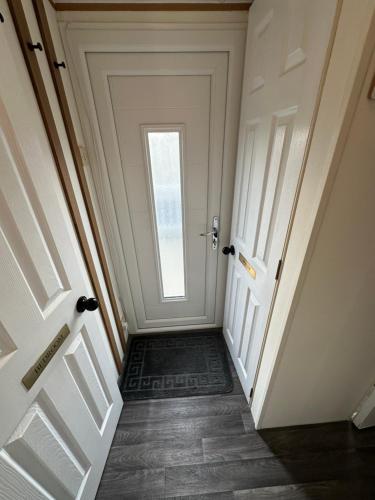 a hallway with a door with a window at 8 berth Waterside Ingoldmells V8 Santanavan 3 in Skegness