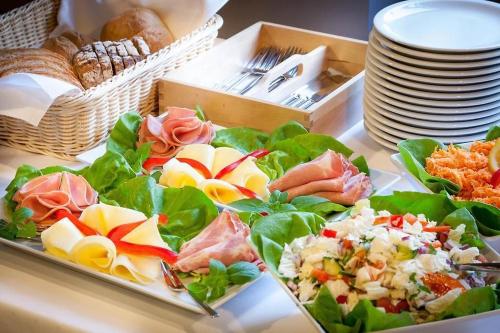 a table with plates of food on top at Albergo KOLODZIEJ in Siemianowice Śląskie