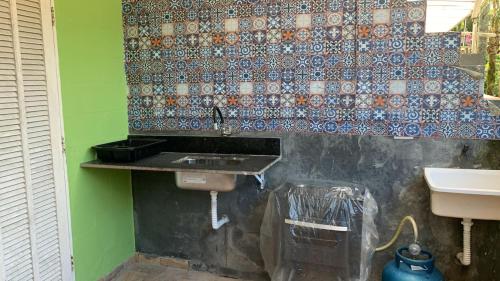 a bathroom with a sink and a toilet and a wall at Solaris do Una in São Sebastião