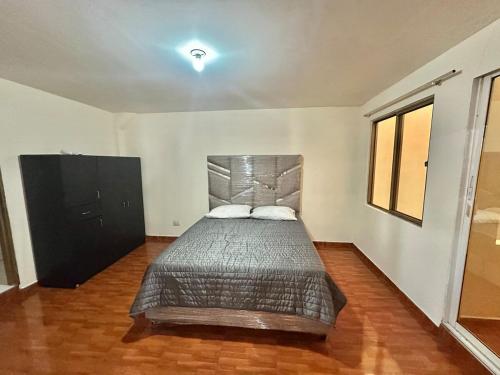 Un dormitorio con una cama y una cómoda. en Apartamento Cerca Aeropuerto, en Cali