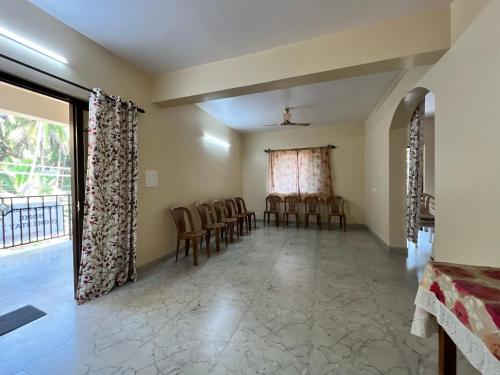 a room with chairs and a dining room with a window at D 'SOUZA HOLIDAY HOME in Benaulim